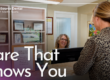 woman smiling checking patient out of dental office